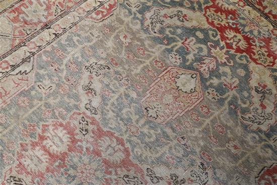 A Turkish blue ground rug, 6ft 5in by 4ft 5in.